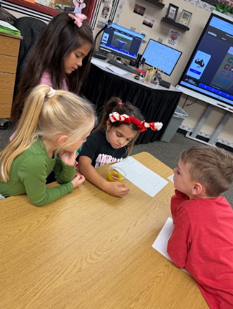 students observing gingerbread cookie floating in a liquid