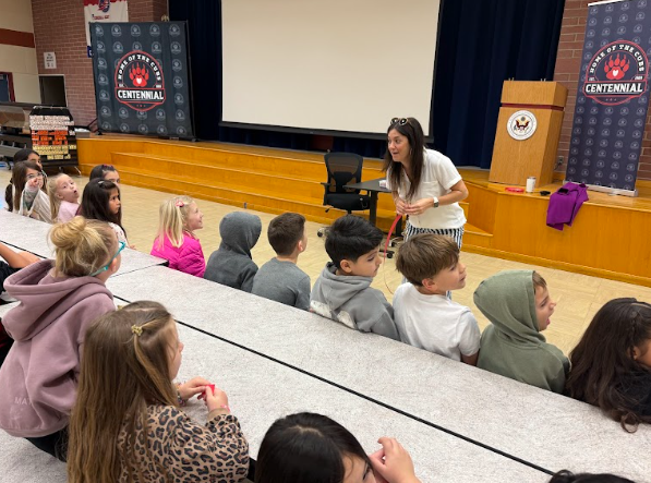 students listening to teacher in cafeteria