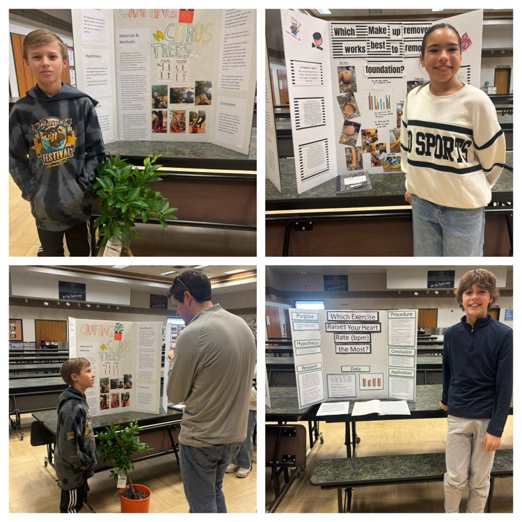 students standing in front of science fair projects
