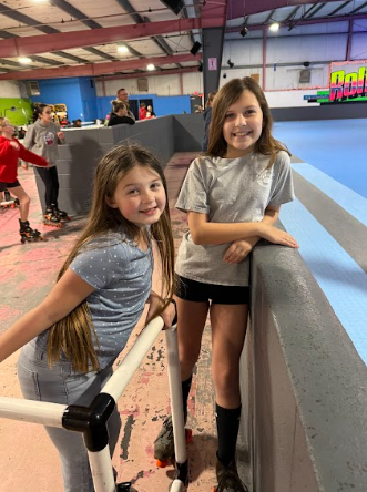 girls at roller rink in skates