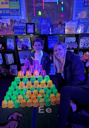 students with cup tower