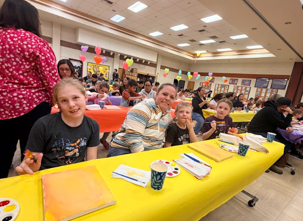 families painting at tables
