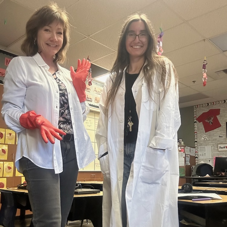 two ladies wearing white coats and gloves