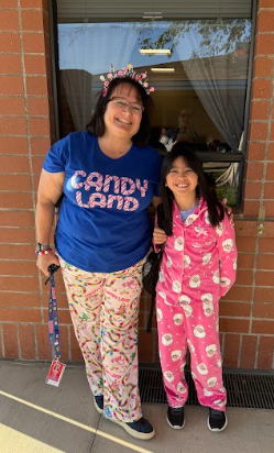 student and principal wearing pajamas