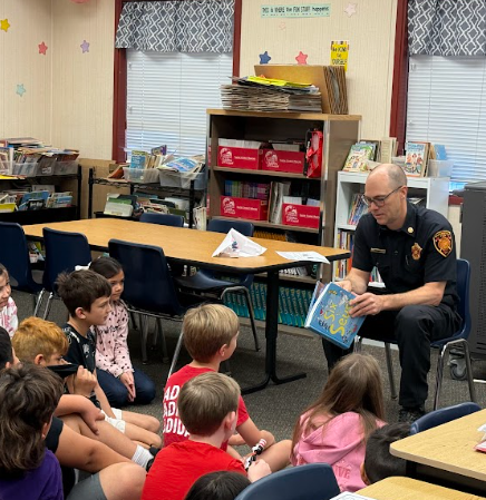 Celebrity reader reading to students