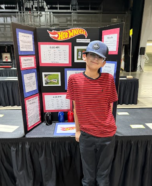 student with a science fair board