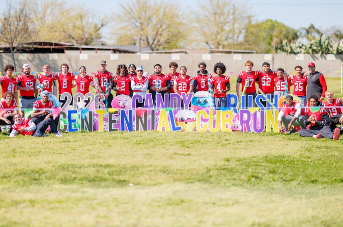 football players In front of a sign
