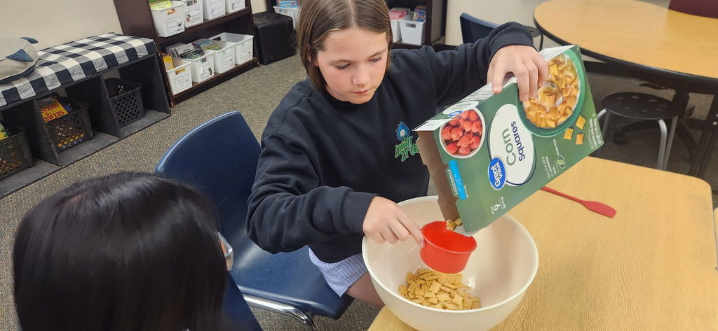 student measuring ingredients