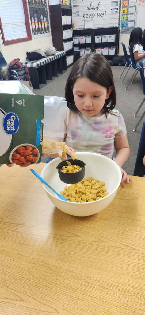 student measuring ingredients
