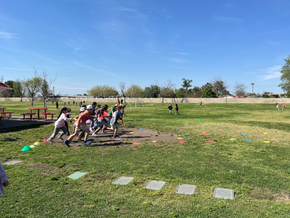 students racing in the grass