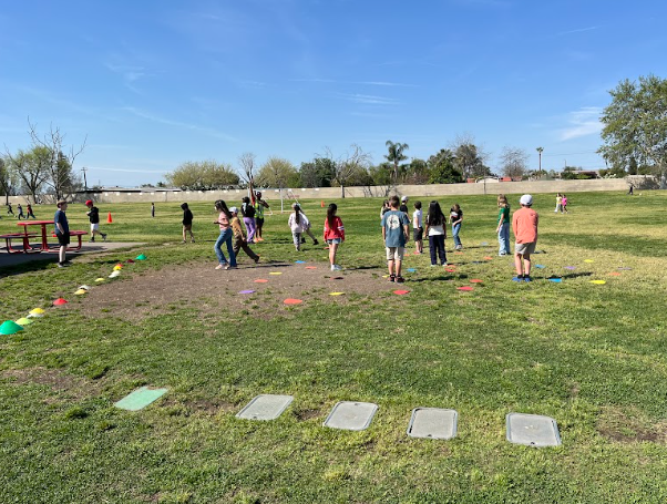 students standing in a grass field