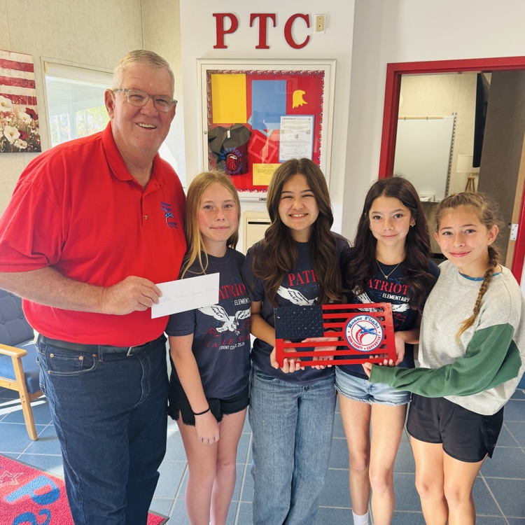 four girls and a gentleman holding a check