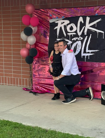 father and daughter getting a picture taken