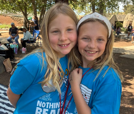 two students standing next to eachother