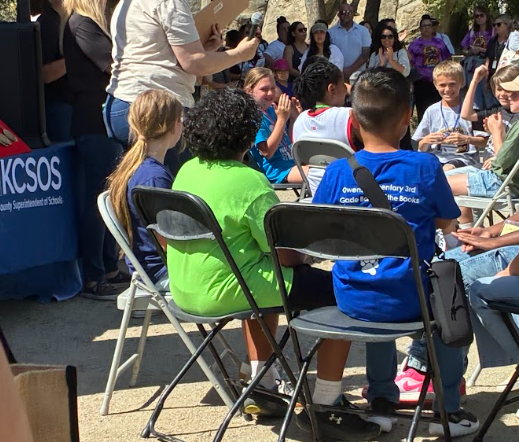 students sitting in folding chairs
