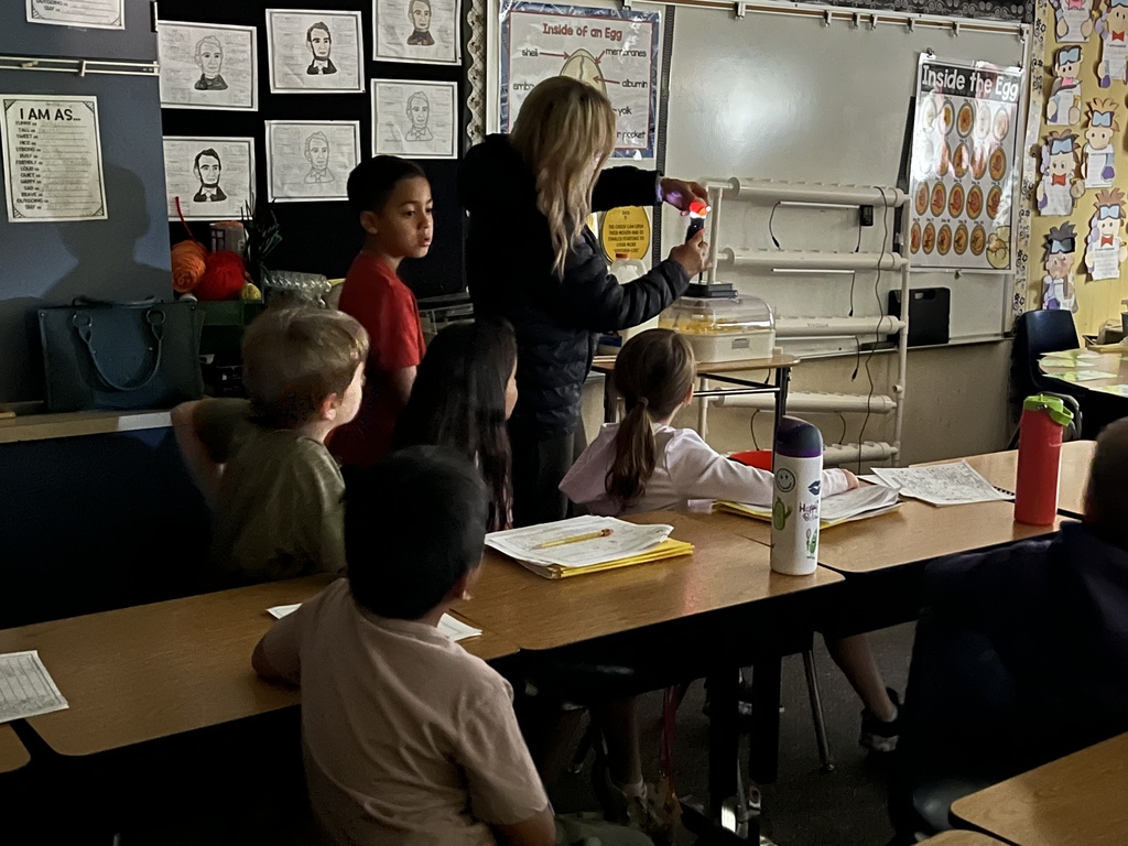 teacher with flashlight and egg