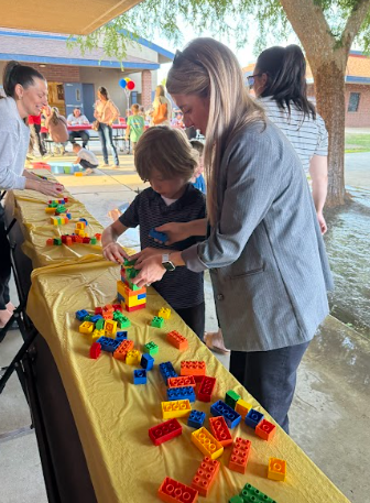 student and mom building  a tower