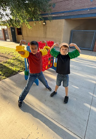 boys with a large connect 4 game