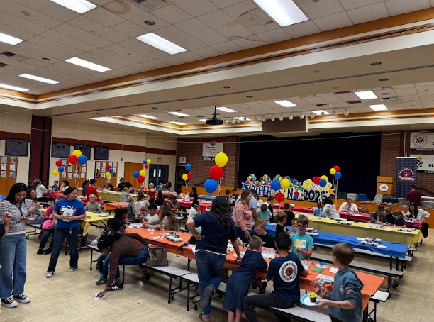 cafeteria filled with people putting together Lego kits