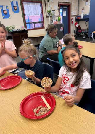 students with bagels string and red plates