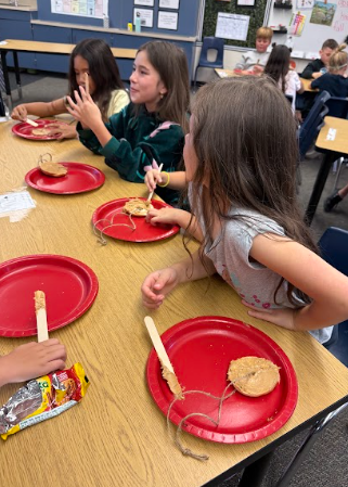 students with bagels string and red plates