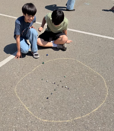 students playing marbles