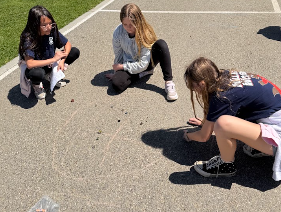 students playing marbles
