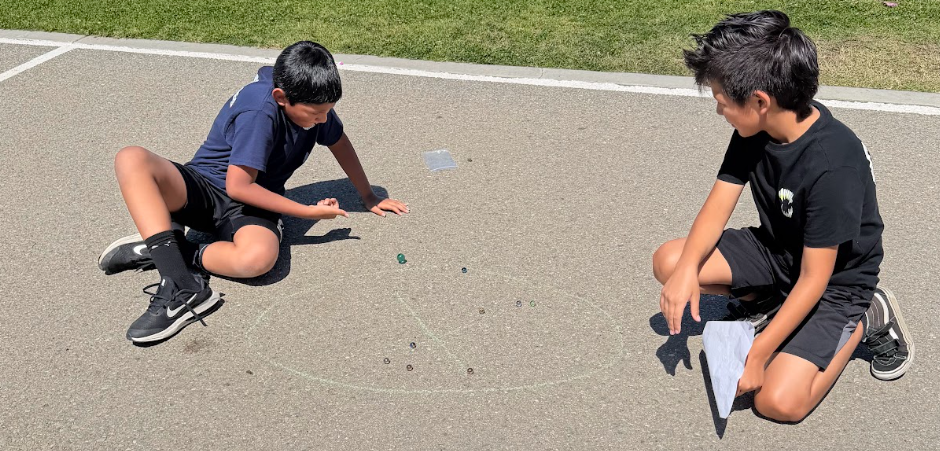 students playing marbles