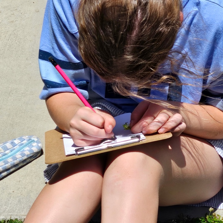 girl writing on a clipboard 