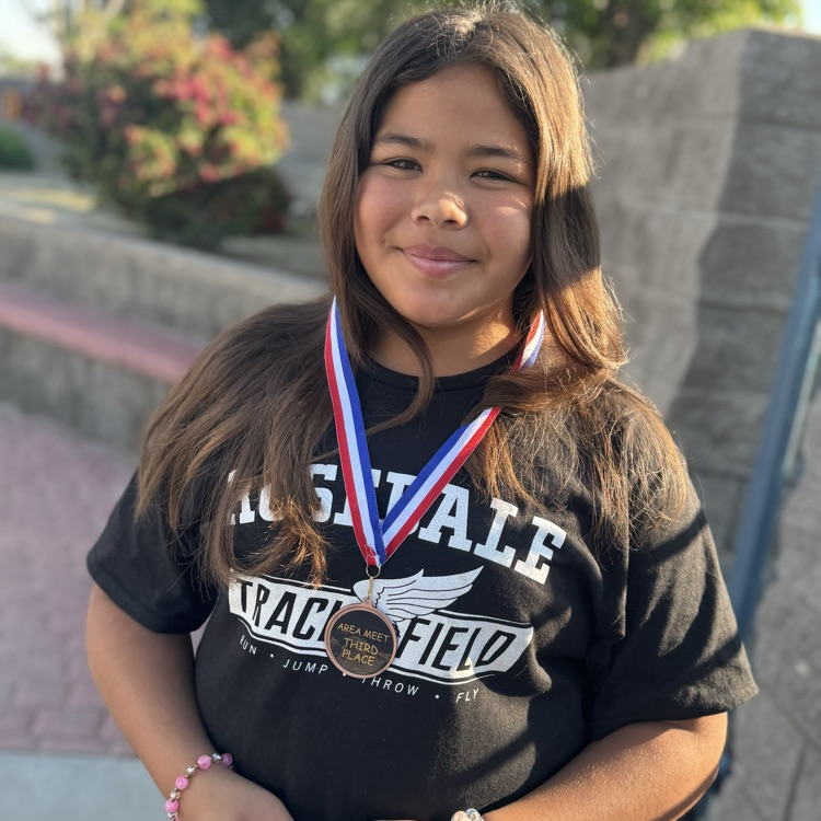 girl wearing a medal earned at track meet