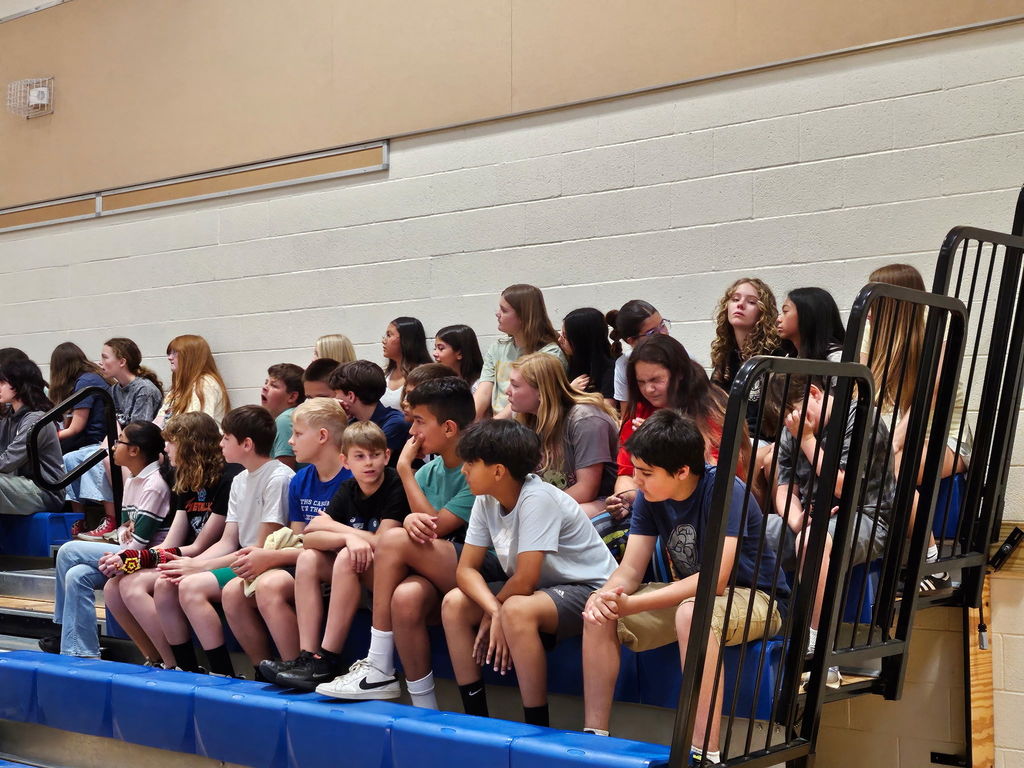 students sitting in bleachers