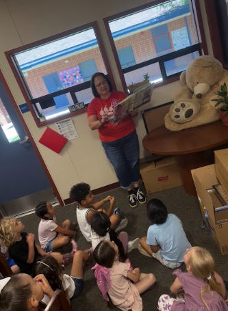 students in the principal's office listening to a story