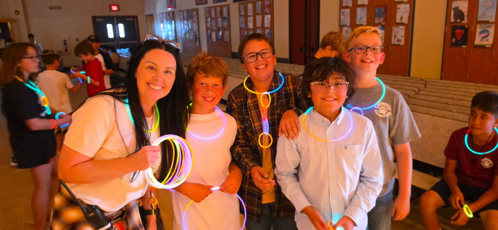 students and teacher with glow sticks