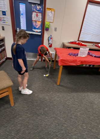 students playing mini golf