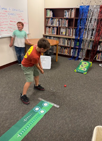 students playing mini golf