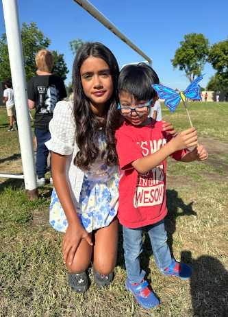 students holding a butterfly puppet