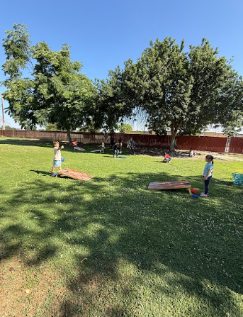 students playing corn hole