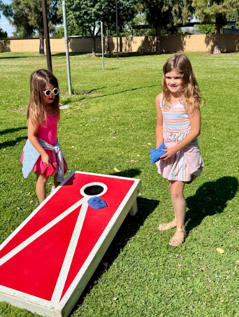 students playing corn hole
