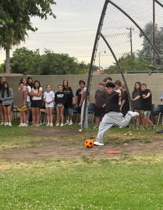 student kicking a ball