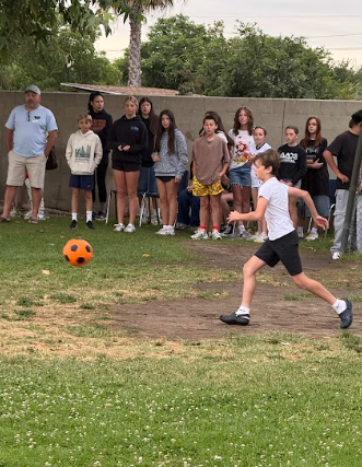 student kicking a ball