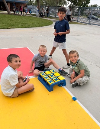 students with big ticktactoe board