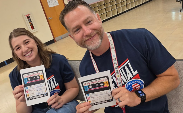 teachers holding up a paper
