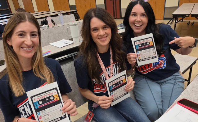 teachers holding up a paper