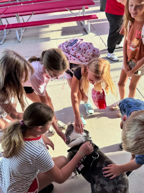 Ottis the dog and students
