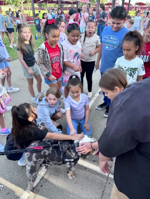Ottis the dog and students