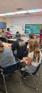 parents listening to a teacher's presentation