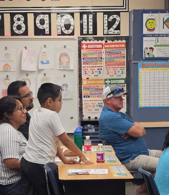 parents listening to a teacher's presentation