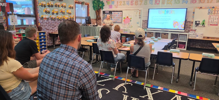 parents listening to a teacher's presentation