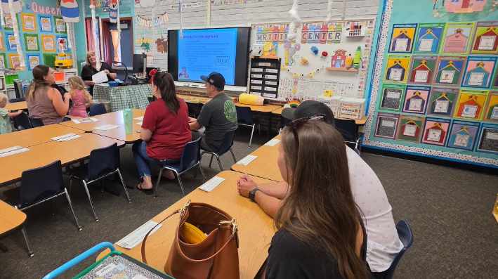 parents listening to a teacher's presentation