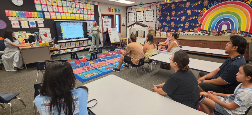 parents listening to a teacher's presentation